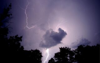 Lightning striking near a residential outdoor air conditioning unit during a summer thunderstorm in Decatur, Georgia.